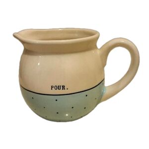 Rae Dunn by Magenta creamer with the word "Pour" blue with black polka dots